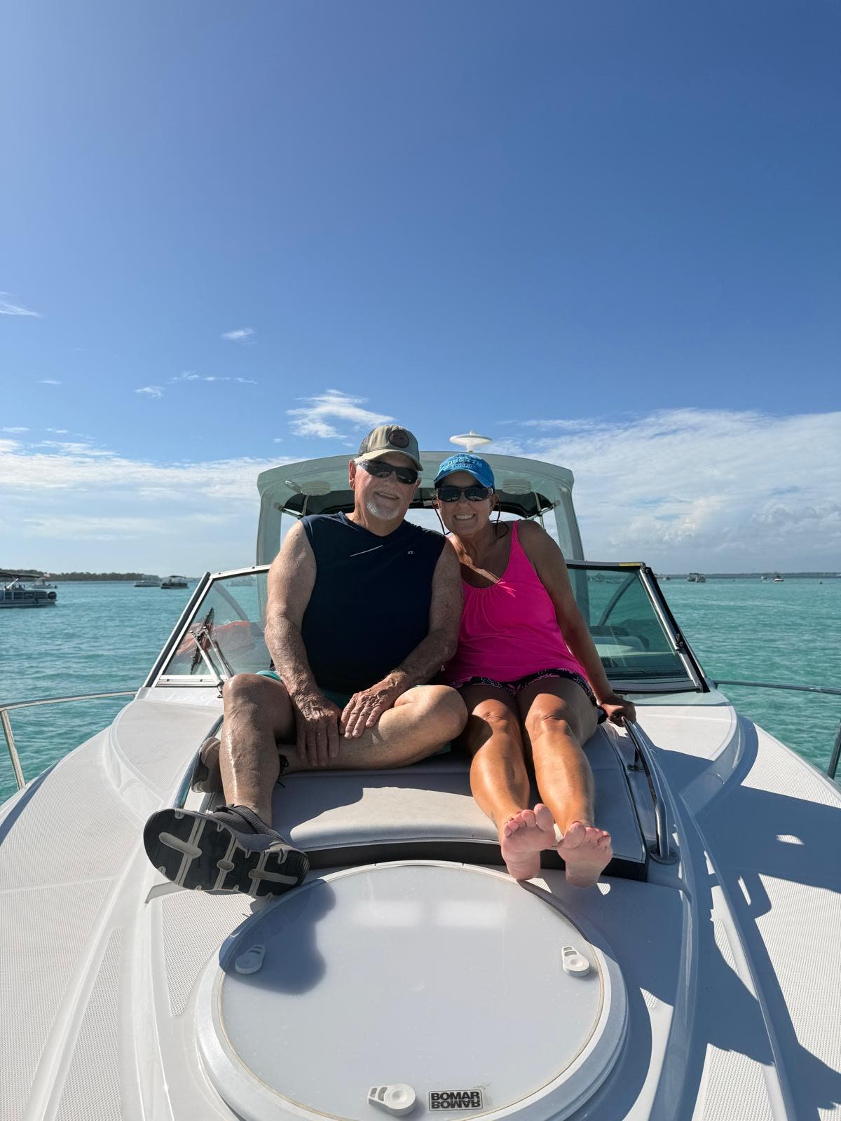 A couple on the bow of the charter boat at golden hour