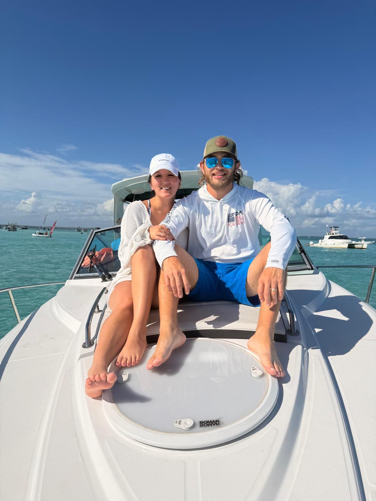 A couple relaxing on the bow of the Salty Crook charter boat
