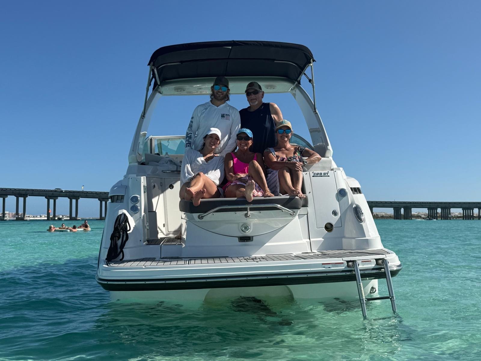 A group of guests gathered on the stern of the charter boat