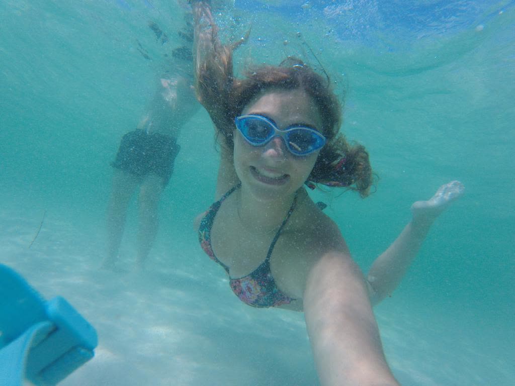 Underwater view of guests swimming with goggles in the clear Emerald Coast water