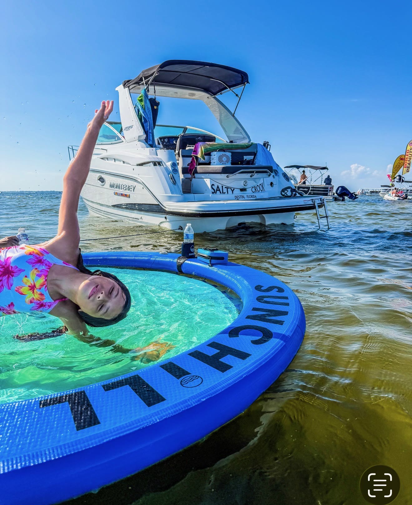 Guests on the bow of the Salty Crook yacht near Destin